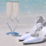 Bridal Shoes and Bridal Champagne Glasses on the Beach